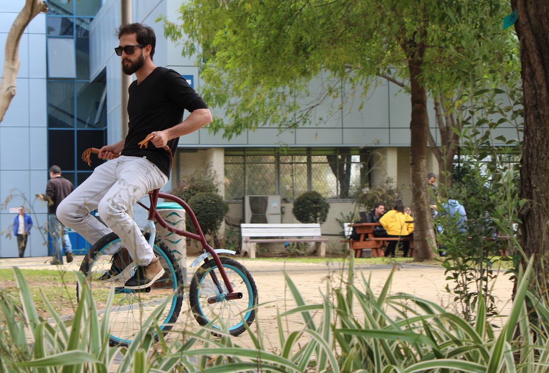 עידן הרבט רוכב על Freak Bike בין עצים ובניינים